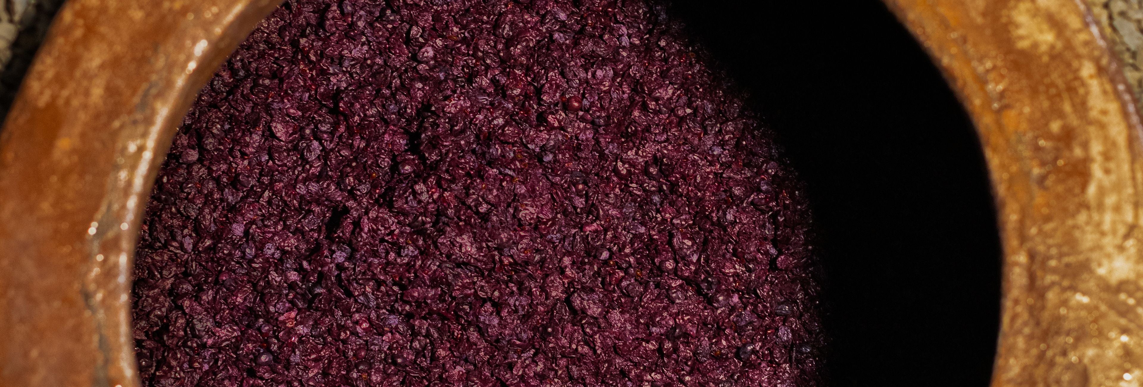 Close-up view of wine fermentation in a traditional Georgian qvevri