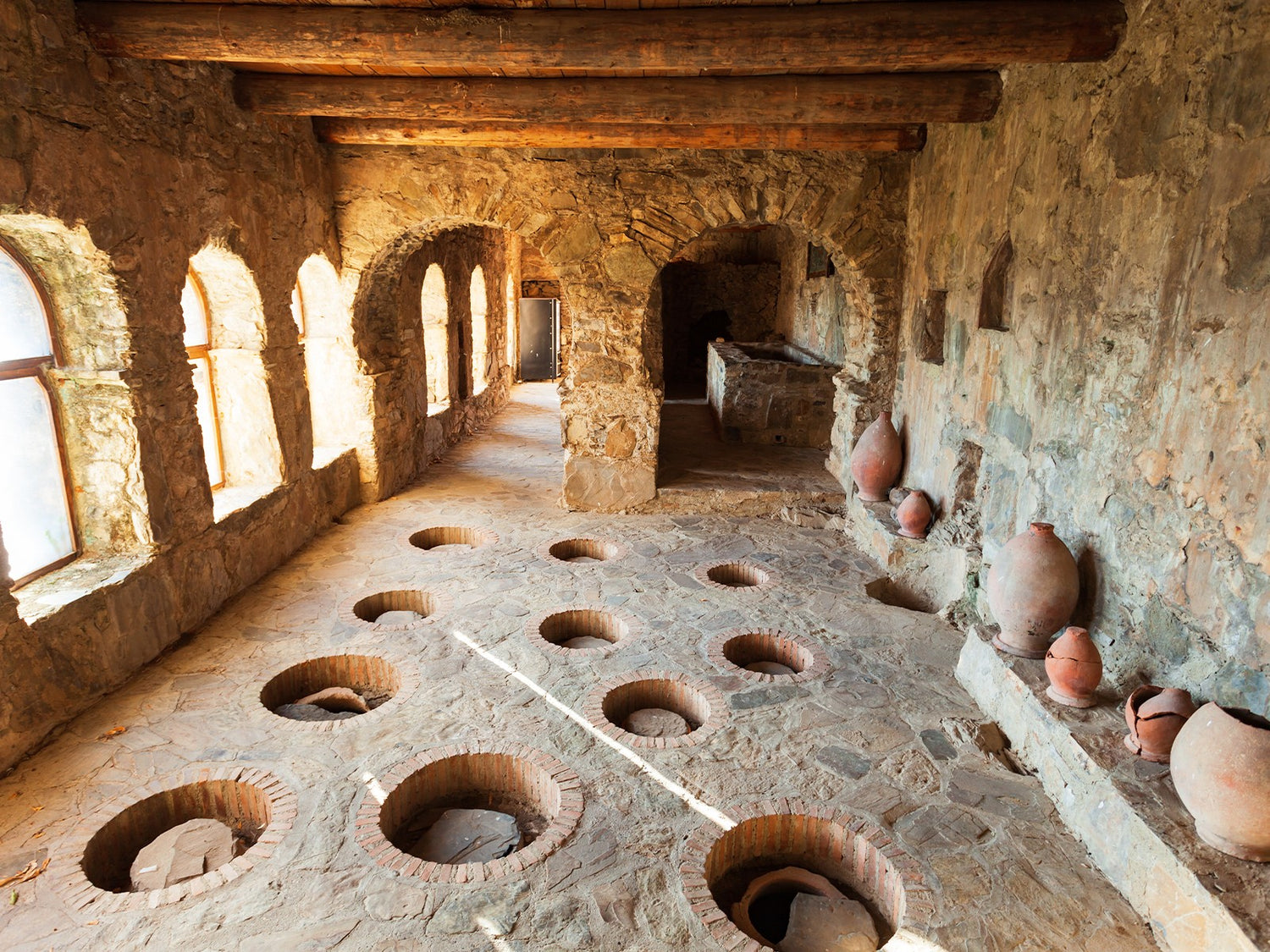 Ancient Georgian winemaking ruins showing numerous qvevri vessels